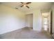 This bedroom has neutral walls, carpet, ceiling fan and an entrance to another room at 3730 Ralston Rd, Plant City, FL 33566