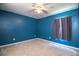 Empty bedroom with blue walls, carpet floors, and a ceiling fan at 3730 Ralston Rd, Plant City, FL 33566