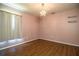 Empty bedroom featuring a chandelier and hardwood floors at 3730 Ralston Rd, Plant City, FL 33566