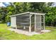 A backyard chicken coop with metal roofing, enclosed pen and mature shade trees at 3730 Ralston Rd, Plant City, FL 33566