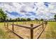 View of the property's horse pen with a large grass field, perfect for equestrian enthusiasts at 3730 Ralston Rd, Plant City, FL 33566