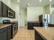 A spacious kitchen with ample dark wood cabinetry, stainless steel appliances, and tile floors at 3730 Ralston Rd, Plant City, FL 33566