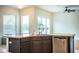 Open-concept kitchen with a stainless steel dishwasher, a modern faucet, and large windows at 3730 Ralston Rd, Plant City, FL 33566