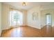 Bright living room with beautiful hard wood floors, an arched window, and natural light at 3730 Ralston Rd, Plant City, FL 33566