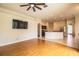 Open-concept living room with hardwood floors seamlessly flowing into the modern kitchen at 3730 Ralston Rd, Plant City, FL 33566