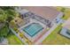 Aerial view showcasing the screened-in pool, fenced backyard, and roof of the home at 4223 Amber Ridge Ln, Valrico, FL 33594