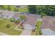 Aerial view of the home with a screened pool and a manicured front lawn enhanced with beautiful landscaping at 4223 Amber Ridge Ln, Valrico, FL 33594