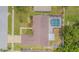 Overhead view of a house featuring a screened-in pool, patio, fenced backyard, and lush landscaping at 4223 Amber Ridge Ln, Valrico, FL 33594