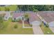 Aerial view of the home featuring a well-maintained lawn, landscaped beds, and a screened-in pool at 4223 Amber Ridge Ln, Valrico, FL 33594