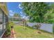 Landscaped backyard featuring a screened-in pool, lush lawn, and privacy fence, creating a serene outdoor space at 4223 Amber Ridge Ln, Valrico, FL 33594