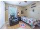 The bedroom includes a ceiling fan, a bed and a leather chair at 4223 Amber Ridge Ln, Valrico, FL 33594