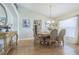 Formal dining room with wood floors, elegant table set, and décor, blending comfort with upscale design at 4223 Amber Ridge Ln, Valrico, FL 33594