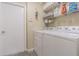Functional laundry room with washer, dryer, shelves, offers practicality and storage space for household needs at 4223 Amber Ridge Ln, Valrico, FL 33594