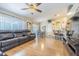 Open-concept living area featuring beautiful hardwood floors, abundant seating, and easy access to the kitchen at 4223 Amber Ridge Ln, Valrico, FL 33594