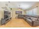 Spacious living room with hardwood floors, ceiling fan, and a large sectional couch for ultimate relaxation at 4223 Amber Ridge Ln, Valrico, FL 33594