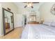The main bedroom has hard wood floors, a ceiling fan and large mirrors at 4223 Amber Ridge Ln, Valrico, FL 33594