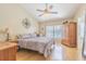 The main bedroom offers a ceiling fan, a window and a reading chair at 4223 Amber Ridge Ln, Valrico, FL 33594