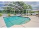Sparkling screened-in pool offers a refreshing oasis with ample space for relaxation and entertaining at 4223 Amber Ridge Ln, Valrico, FL 33594