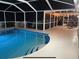 Inviting pool and patio with string lights perfect for relaxing evenings, offering a private outdoor retreat at 4223 Amber Ridge Ln, Valrico, FL 33594