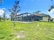 Backyard featuring a screened-in pool with ample space for outdoor activities and relaxation at 4592 Crabapple Ave, North Port, FL 34287