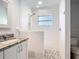 Bright bathroom featuring a modern walk-in shower and stylish vanity with granite counters at 4592 Crabapple Ave, North Port, FL 34287