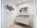 Bathroom featuring a vanity with marble countertop and decorative mirror at 4592 Crabapple Ave, North Port, FL 34287