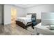 Modern bedroom with neutral tones, wood-look floors, and ensuite bathroom at 4592 Crabapple Ave, North Port, FL 34287