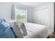 This bedroom features a large window with an outside view, a closet, and hardwood floors at 4592 Crabapple Ave, North Port, FL 34287