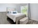 Bright bedroom with hard floors, a large window, bench and a full sized bed at 4592 Crabapple Ave, North Port, FL 34287