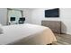 Bedroom setup as a home office featuring a large bed, a dresser, and light wood flooring at 4592 Crabapple Ave, North Port, FL 34287