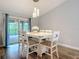 Bright dining room with seating for six and sliding glass doors to the pool area at 4592 Crabapple Ave, North Port, FL 34287