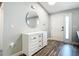 Bright foyer with wood-look floors, a modern dresser, and a mirror, creating a welcoming entrance at 4592 Crabapple Ave, North Port, FL 34287