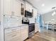 Bright kitchen with white cabinets, stainless steel appliances, and a breakfast nook with a view at 4592 Crabapple Ave, North Port, FL 34287