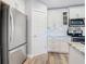 Bright kitchen features white cabinets, granite countertops and stainless steel refrigerator at 4592 Crabapple Ave, North Port, FL 34287