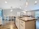 Open-concept kitchen features an island with seating and a view into the dining area at 4592 Crabapple Ave, North Port, FL 34287