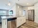Modern kitchen with stainless steel appliances, granite countertops, and an island with sink at 4592 Crabapple Ave, North Port, FL 34287