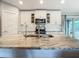 Modern kitchen featuring stainless steel appliances, stylish backsplash, and a large center island with a sink at 4592 Crabapple Ave, North Port, FL 34287