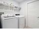 Well-lit laundry room featuring modern Samsung washer and dryer with wire shelving for convenient storage at 4592 Crabapple Ave, North Port, FL 34287