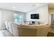 Comfortable living room with a large sectional sofa, TV, and a bright window at 4592 Crabapple Ave, North Port, FL 34287