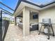 Inviting outdoor living space with comfortable seating, mounted TV, and convenient solo stove for year-round enjoyment at 4592 Crabapple Ave, North Port, FL 34287