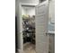 Well-organized pantry with shelving and pull-out baskets for optimal storage, and hardwood floors at 4592 Crabapple Ave, North Port, FL 34287