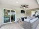 This covered patio features tile floors, an outdoor ceiling fan, and sliding glass door at 4592 Crabapple Ave, North Port, FL 34287