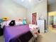 Bedroom includes bright colored bedding, neutral walls, and decorative accessories at 4611 Executive Meadows Dr, Plant City, FL 33567