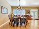 Bright dining area featuring hardwood floors, a chandelier, and views of the backyard at 4611 Executive Meadows Dr, Plant City, FL 33567