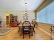 Dining room with a chandelier, hardwood floors, and large windows offering natural light at 4611 Executive Meadows Dr, Plant City, FL 33567