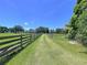 Long driveway leads to this home on a sprawling lawn, with mature trees and fenced border at 4611 Executive Meadows Dr, Plant City, FL 33567