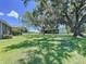Large backyard featuring open lawn, mature trees, and a spacious covered barn at 4611 Executive Meadows Dr, Plant City, FL 33567