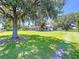 Charming home on a sprawling lawn, with mature trees and a covered porch at 4611 Executive Meadows Dr, Plant City, FL 33567