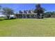 Spacious two-story home with a large front yard and covered porch, perfect for enjoying the outdoors at 4611 Executive Meadows Dr, Plant City, FL 33567