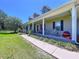 Inviting home with a wide porch, dark shutters, and landscaped garden, creating a welcoming curb appeal at 4611 Executive Meadows Dr, Plant City, FL 33567